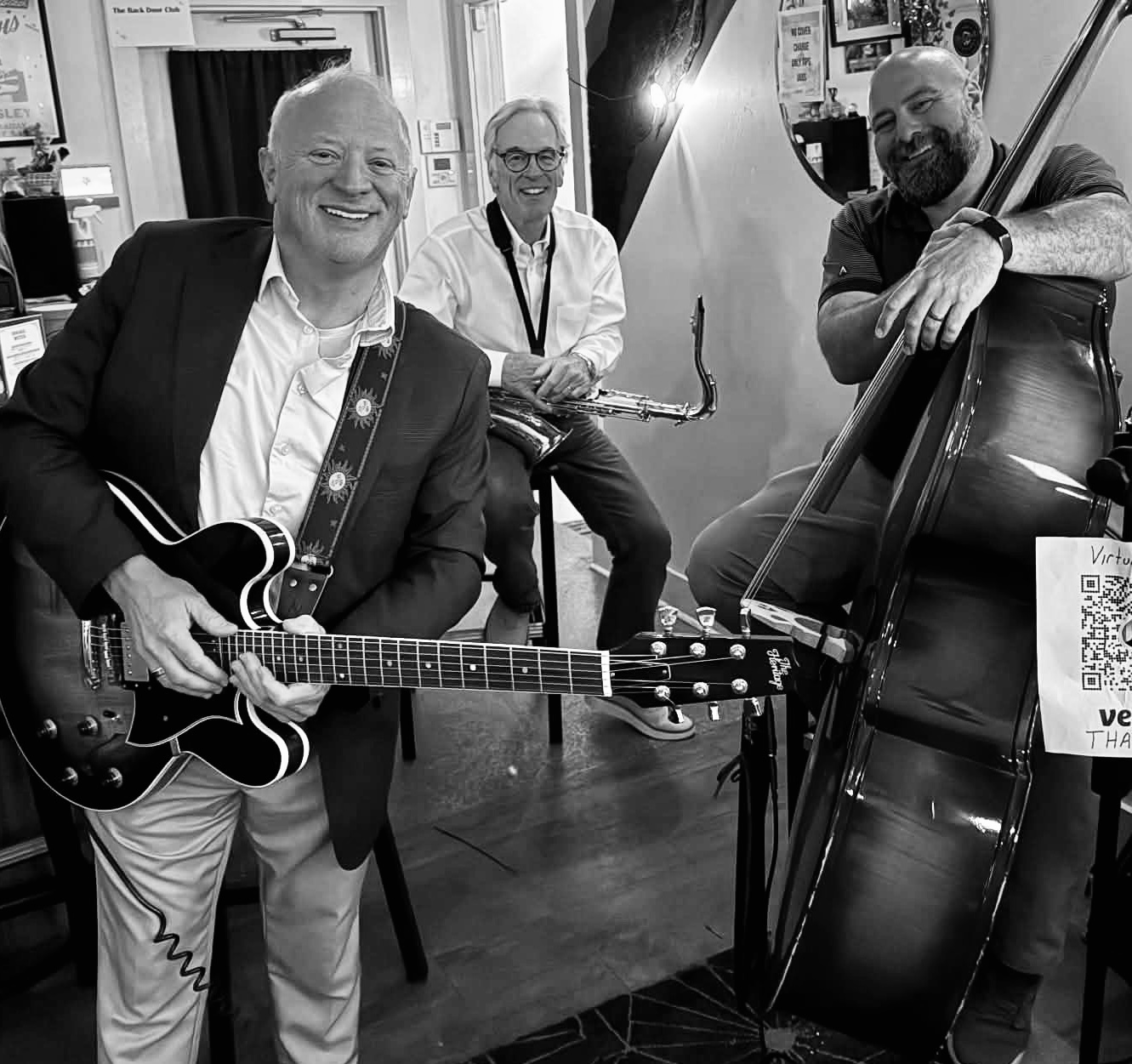 Jordan Tupper on upright bass, Jim Standley on guitar, and Glen Petersen on tenor saxophone performing live jazz in Baton Rouge